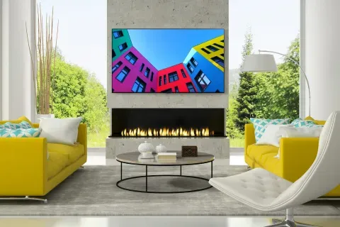 lg-75QNED99UQA-yellow-couches-fireplace